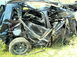 The badly damaged car of the victim which was hit by a train at an unmanned level crossing