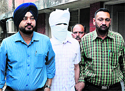 The accused ASI in the custody of the Vigilance Bureau in Ludhiana on Tuesday. He was reportedly caught taking a bribe from a woman to help her in a case
