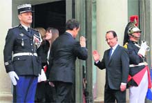 Outgoing French President Nicolas Sarkozy (left) waves goodbye to new President Francois Hollande at the Elysee Palace after the handover ceremony on Tuesday.