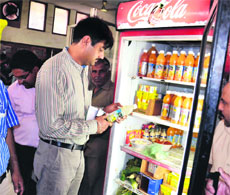 A member of a health department team inspects food items at DAV School in Amritsar on Wednesday. 