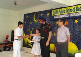 Col BS Brar, CO, Bathinda Military Station, giving badge to a student during a investiture ceremony of the Delhi Public School, Bathinda, on Tuesday