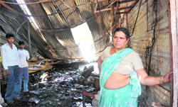 A woman at her shop which was gutted at a furniture market in Chandigarh. Tribune photo: Pradeep Tewari