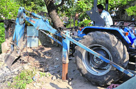 Machinery being used to demolish illegal structures in Mandi on Wednesday.
