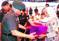 The Army Chief, General VK Singh, honours a war widow at Palda village in Jhajjar disrict on Wednesday.