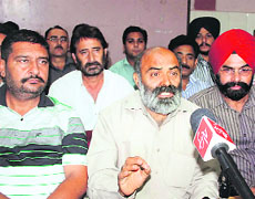 Ram Kumar, senior leader of the Joint Consultatiive Committee of J&K government employees, addresses a press conference in Jammu on Wednesday. 