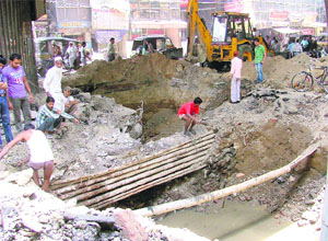 The municipal corporation repairs the spot near Clock Tower that caved in, in Ludhiana on Wednesday.