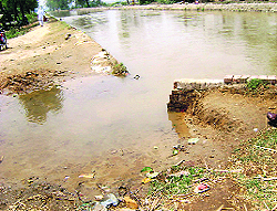 A minor breach in the bank of a water channel