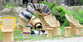A seller of bamboo chair takes a nap along the NH-1 near Babarpur in Panipat.