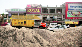 Heaps of construction material lie on the Kunjwani-Satwari national highway in Jammu.