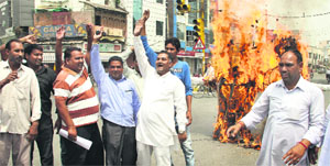 Workers and leaders of the BSP burn effigies of Union Minister for Human Resource Development Kapil Sibal and Punjab Chief Minister Parkash Singh Badal in Jalandhar on Thursday.
