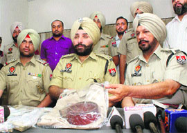 Patiala SSP Gurpreet Singh Gill shows police uniform seized from robbers in Rajpura.