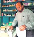 A health official conducts a raid on a medical store at Waryam Nangal village.