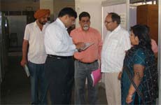 Members of a team checking the attendance register of the employees at one of the offices in district administrative complex in Bathinda on Friday. 