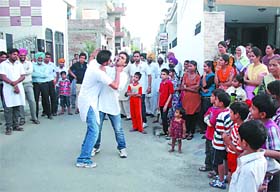A scene from the street play Samajhdar Log being enacted in Hazura Kapura colony on Friday.