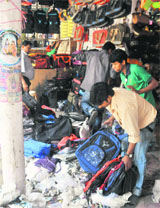 Workers remove encroachments at Sadar Market, Sector 19, Chandigarh on Friday.