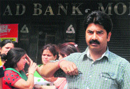 Bharat Bhushan with his family members outside Allahabad bank at Phase 9 in Mohali on Friday. 