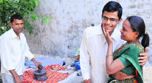 Sunil with his mother and father after the declaration of the IIT result on Friday. 