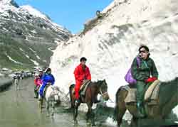 Tourists enjoy a horse ride at Beas Nullah, about 30 km from the Rohtang Pass. Photo by writer
