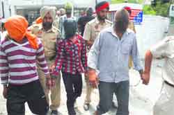 The accused in police custody in Jalandhar on Friday. Tribune photo: Malkiat Singh 