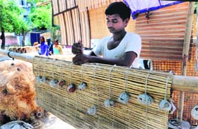 A worker prepares bamboo chick blinds at Sector 22 in Chandigarh