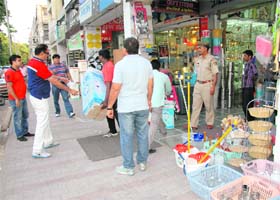 Municipal Corporation team conduct an anti-encroachment drive in Sector 18 of Chandigarh on Saturday