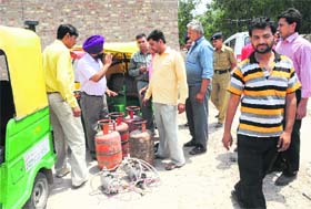 Police checks illegal gas filling at the Sector-38 service station in Chandigarh on Saturday