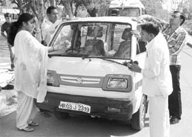 Members of teachers association clean a car