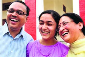 Jhanvi Shrivastava of St Joseph's Academy with her parents in Dehradun on Saturday