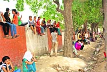 The agitating girls outside the main gate of BPS Women University at Khanpur Kalan in Sonepat on Saturday. 