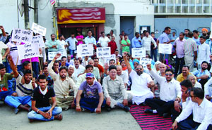 Congress workers hold a protest outside the Division No 5 police station in Jalandhar on Saturday. 