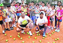 Tennis coaches Prince (L) and Manjeet with their students