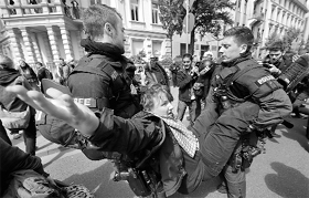 An Occupy activist is carried by the police in Frankfurt.