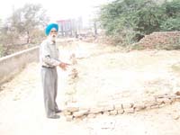 TS Sandhu, a retired SDO, showing the portion of his 270 square yards plot, a part of which has been encroached upon by the Municipal Corporation.