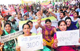 Teachers stage a protest in support of their demands in Mohali on Sunday.
