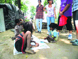 Volunteers of Making A Difference (MAD) work with slum children of the Bihari basti in Dehradun on Sunday.