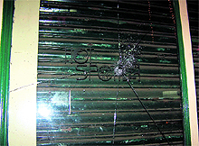 A windowpane damaged by hooligans at McLeodganj on Sunday