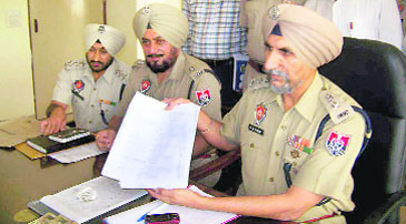SSP Ferozepur Hardial Singh Mann shows the fake PMET paper.