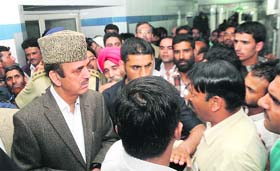Union Health Minister Ghulam Nabi Azad listens to a patients attendant during his visit to GB Pant Hospital in Srinagar on Sunday