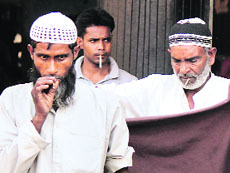 Throwing ban to the winds, people are seen smoking at the Jammu bus stand on Sunday.