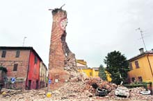 Damaged cars after a tower collapsed following Sundays quake at Finale Emila in Italy.