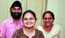Arshdeep Kaur (left) who is the co-topper in PMET-2012 with her parents in Bathinda on Monday night.