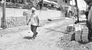 A metalled road that was dug up for laying inter-locking tiles at Sewak Colony in Patiala. 