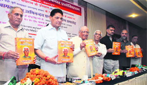 Former Uttarakhand CM Nityanand Swami (third from left) with state Health Minister Surendra Singh Negi (second from left) release a book by Dr Mayaram Uniyal (fourth from left) in Dehradun on Sunday.