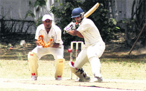 A batsman plays a shot in a match during the 30th All-India Uttarakhand Gold Cup Cricket Tournament in Dehradun on Monday