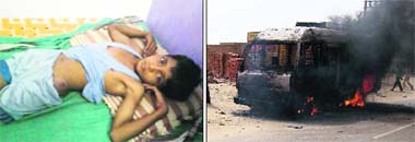 An injured schoolboy who was hurt in the lathi charge (left) and government vehicles torched by the police (right) at Kagdana village in Sirsa following a clash between the police and villagers on Monday