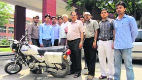 Students and teachers of Deenbandhu Chhotu Ram University of Science and Technology, Murthal, demonstrate the motorcycle innovated by them on the university premises in Sonepat