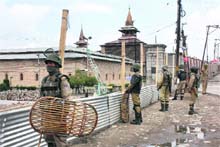 Security personnel stand guard outside Jamia Masjid in Srinagar on Monday. It is the first time in over two decades that the authorities did not allow separatist leaders to hold a rally marking the 22nd death of anniversary of Mirwaiz Mohammad Farooq and Abdul Gani Lone.