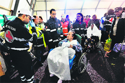 Evacuated citizens receive assistance in the tent camp building in Finale Emilia village on Monday.  AFP
