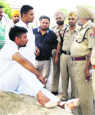 Police officials question the injured Om Prakash at the spot where two groups of liquor contractors opened fire at each other. 