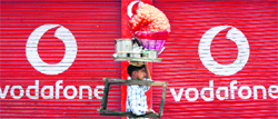 A closed shop displaying the Vodafone logo in Jammu. The CEO of Vodafones Indian unit said Tuesday the latter may not launch a planned IPO this year if the government accepts TRAIs spectrum auction proposals  Reuters